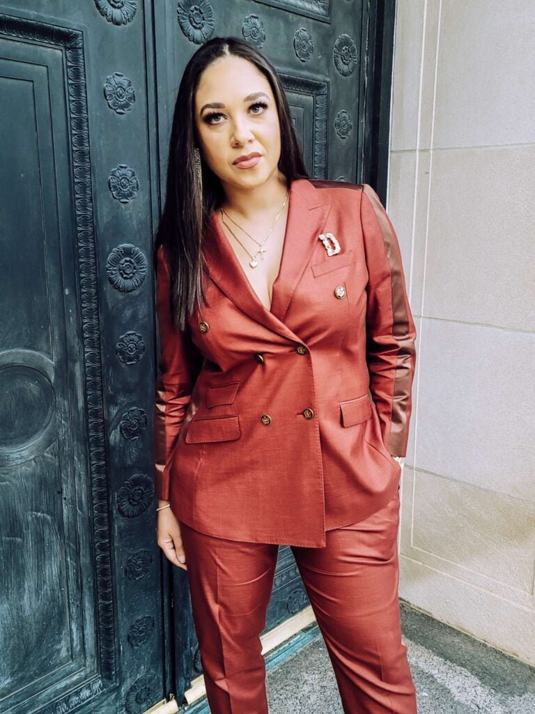 DeNira Dedeaux wearing a red rust Sean M Horton Atelier women's custom suit Kansas city